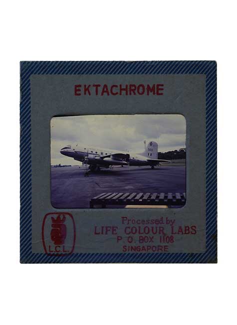 An Ektachrome film of a plane on a runway.