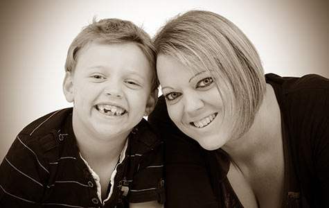 A mother and son smiling